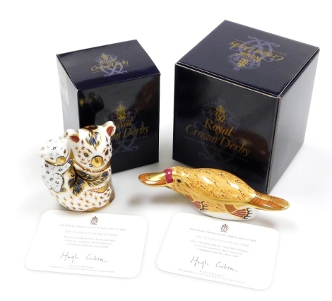 Two Royal Crown Derby porcelain paperweights from The Australian Collection, Koala and Baby, gold stopper and gold printed marks, 10cm high, and Duck-Billed Platypus, gold stopper and gold printed marks, 18cm wide, both boxed with certificates. (2)