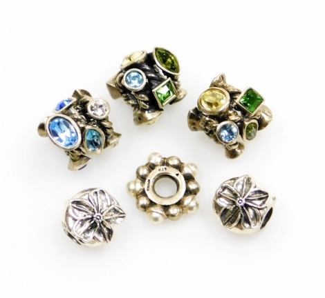 Six various charms, each stamped Cham, to include three stone set examples, two lotus flowers and a pearl breaker, all stamped 925, 19.7g all in. (6)