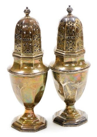 A pair of George V silver sugar castors, each with an orb finial, pierced lid and shaped body on a stepped foot, one with presentation inscription for Belton Park Golf Club (36 hole Medal Finals) R E C Whysall, 12 & 67= 139, Sept 1928, Birmingham 1926 and