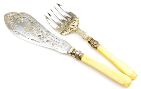 A pair of Victorian plated fish servers, with ivory handles, and pierced and engraved decoration.