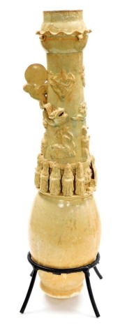 A Chinese Ching-pai type porcelain granary vase, with applied band of robed figures below appliqué dragon, sun and other embellishments, late Southern Song/Yuan dynasty, 73cm high.