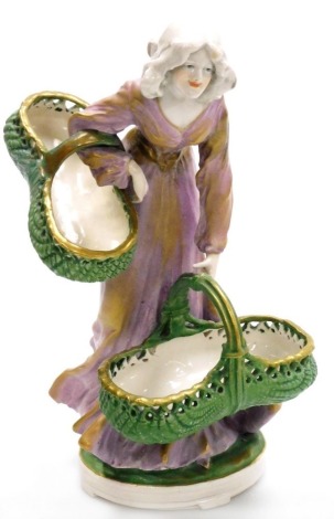 An Imperial Amphora Austrian pottery figure of a lady, in a lilac gilt highlighted gown holding two baskets, impressed marks and pattern number 4975, 25cm high.