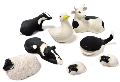 A group of Highbank porcelain animal figures, comprising bull, 8cm high, duck, 9cm high, whale, 5cm high, badger, 5cm high, sheep and two lambs, 7cm wide and 5cm wide respectively, and sheep dog, 12cm wide.