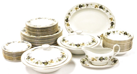 A Royal Doulton porcelain Larchmont pattern part dinner service, comprising oval meat platter, pair of vegetable tureens and covers, sauce boat on stand, twelve dinner, ten dessert and nine side plates and eleven dessert bowls.