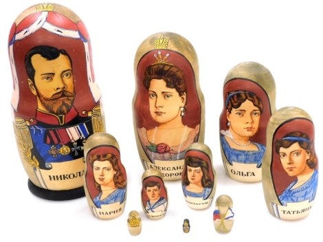 A Russian Matryoshka doll set of the Romanov Family, comprising Tsar Nicholas II, his wife Alexandra, children Olga, Tatiana, Maria, Anastasia, and Alexei, Russian flag, Imperial crown and a miniature candle, the largest 6cm, the smallest 1.5cm high. (9)