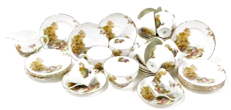 A Shelley porcelain Heather pattern part tea service, comprising twelve teacups, twelve saucers, six cake plates, sugar bowl and milk jug.