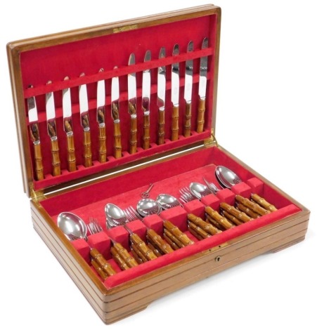 A Sanenwood stainless steel canteen of cutlery, each with a simulated bamboo handle, contained in an oak case.