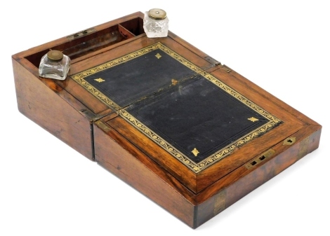 A Victorian walnut and brass bound writing slope, the hinged lid enclosing a leather and gilt tooled inset, two ink pots and pen recess, 15cm high, 30cm wide, 22cm deep.