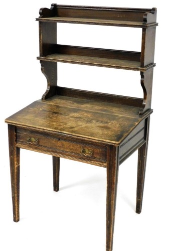 A Victorian Gillow & Company of Lancaster oak clerk's desk, with a two shelf ledger super structure, above a desk with hinged slope, over a single frieze drawer, raised on channelled square legs, 139cm high, 76cm wide, 56cm deep.