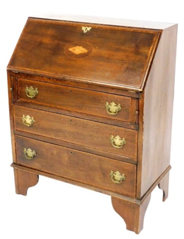 An Edwardian mahogany and satinwood cross banded bureau, the fall flap with shell patera opening to reveal six recesses and a draw, over three long graduated drawers, raised on bracket feet, 95cm high, 74cm wide, 39cm deep.