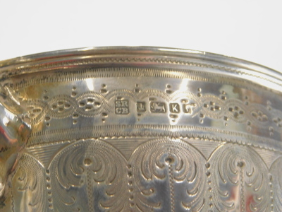 A Victorian silver trophy, with bright cut body, acanthus leaf handles, inverted stem and circular foot, marked By The Gentry And Tradesmen Of Branston On Approaching Marriage 1889, Sheffield 1877, 27cm high, 16oz. - 6