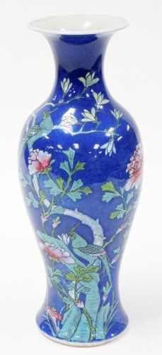 A 19thC Chinese porcelain powder blue baluster vase, decorated in coloured enamels with peony and wisteria, embellished with exotic birds and butterfly, 36cm high.