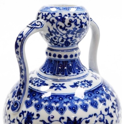 A fine Chinese blue and white porcelain vase, of bulbous shape with two handles, decorated with a band of formal scrolling peonies within bands of lappets, further scrolls and keyfret designs, the base with six character seal mark of Yongzheng period, but - 7