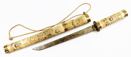 An early 20thC Japanese bone mounted tanto, carved to the handle and sheath in low relief with figures, with brass mounts and caps, steel blade, 44.5cm total length.
