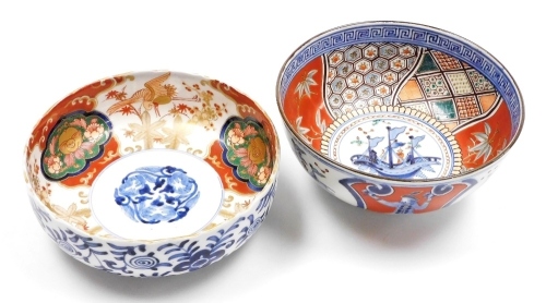 A Japanese porcelain Imari bowl, with wavy rim, painted with panels of storks and bats, 18.5cm diameter, and another Imari bowl decorated with three masted ships and Dutchmen, 18.5cm diameter.