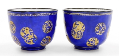 A pair of 19thC Chinese Canton enamel wine cups, decorated with overlapping gilt roundels on a blue ground, 6cm high. - 4