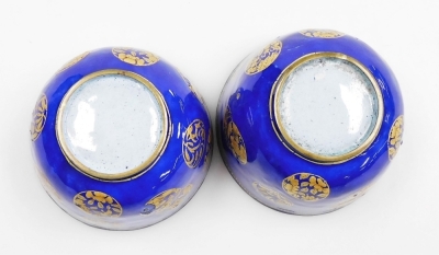 A pair of 19thC Chinese Canton enamel wine cups, decorated with overlapping gilt roundels on a blue ground, 6cm high. - 6