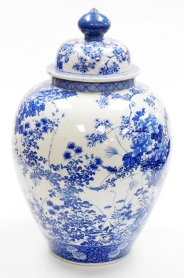 A Japanese Meiji period Seto blue and white porcelain vase and cover, of ovoid form, profusely decorated trees, flowers and blossom, within geometric and scroll banding, 56cm high. (AF) - 3