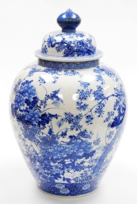 A Japanese Meiji period Seto blue and white porcelain vase and cover, of ovoid form, profusely decorated trees, flowers and blossom, within geometric and scroll banding, 56cm high. (AF) - 4