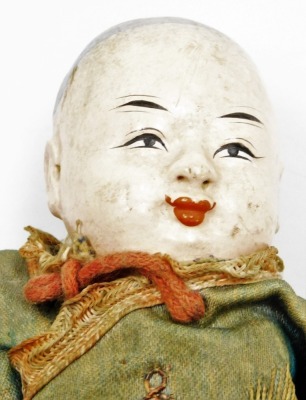 A late 19thC Chinese papier mache and wooden doll, with embroidered red trousers and green tunic, 19.5cm high. - 2