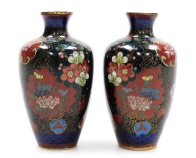 A pair of Japanese Meiji period cloisonne vases, decorated with panels of butterflies and flowers, 9cm high.