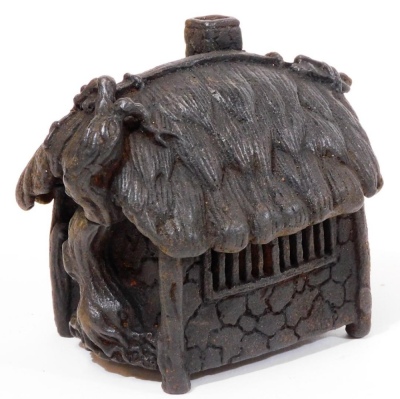 A Japanese iron koro and cover, shaped as a thatched hut, with vine growing up one side, Taisho period, 7cm high.
