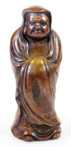 A Japanese Bizen figure of the Buddhist monk Daruma in standing pose, Meiji period, 25.8cm high.