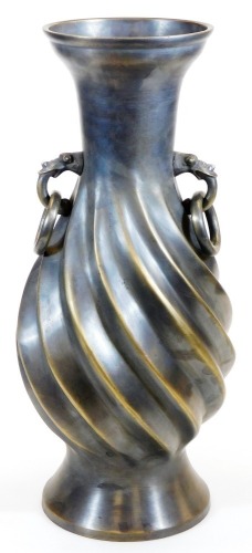 A large Japanese bronze vase, the body with relief spiral twist and loose ring animal head handles, Taisho period, 48cm high.