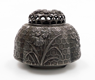 An early 20thC Japanese white metal koro and cover, with high relief floral decoration on a relief honeycomb background, all on four feet, 8cm high. - 3