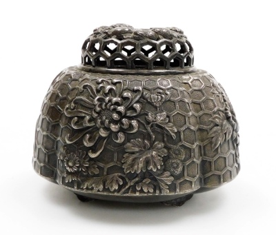 An early 20thC Japanese white metal koro and cover, with high relief floral decoration on a relief honeycomb background, all on four feet, 8cm high. - 4