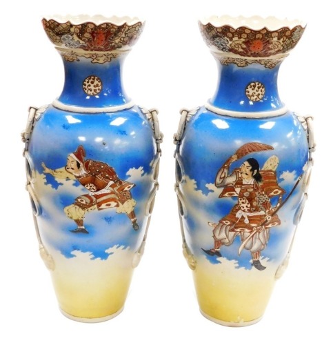 A pair of Japanese Meji period ovoid vases, with foliate rims and applied ring handles, with painted figures of Samurai on a sprayed blue and yellow ground, 54.4cm high.