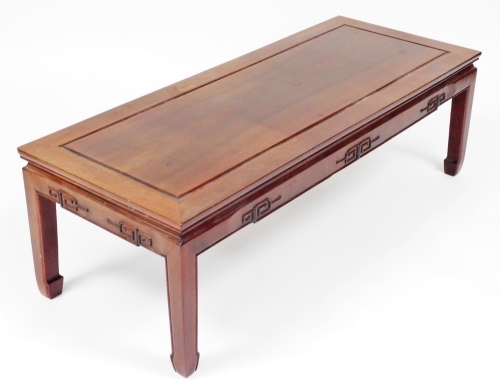 A Chinese hardwood coffee table, 41cm high, the top 50cm x 127cm.