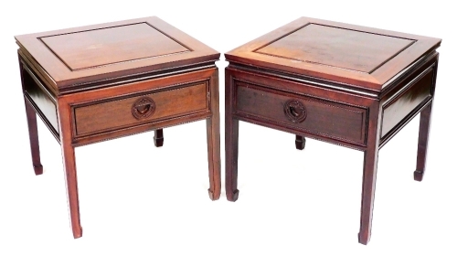 A pair of Chinese hardwood occasional tables, with a frieze drawer and carved wooden handles, 55cm high, the top 56cm x 56cm.