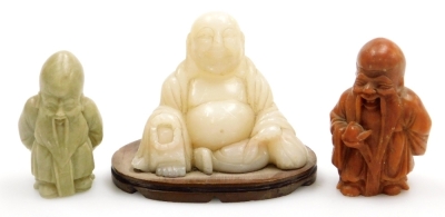 Three Chinese soapstone figures, comprising a seated Buddha on an oval base, 8.5cm wide, together with two carvings of Shou-Lao, one holding a peach, 6.5cm high, and 6cm high. (AF)