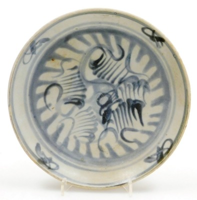 An early 19thC Teksing shipwreck pottery blue and white dish, bears Teksing label, 18cm diameter.