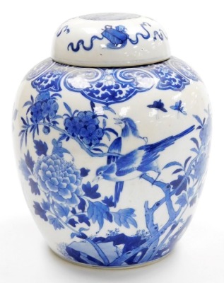 A 19thC Qing dynasty porcelain blue and white ginger jar and cover, painted with birds and flowers within a ryui border, the lid with Buddhistic emblems, bearing a four character Qianlong mark, 24cm high.