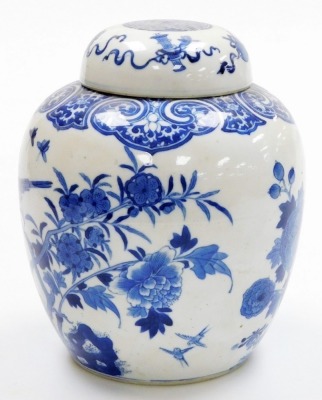 A 19thC Qing dynasty porcelain blue and white ginger jar and cover, painted with birds and flowers within a ryui border, the lid with Buddhistic emblems, bearing a four character Qianlong mark, 24cm high. - 2