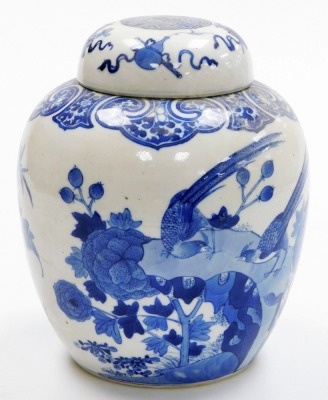 A 19thC Qing dynasty porcelain blue and white ginger jar and cover, painted with birds and flowers within a ryui border, the lid with Buddhistic emblems, bearing a four character Qianlong mark, 24cm high. - 3