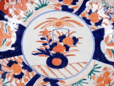 A Japanese Meiji period Imari charger, of fluted form, the centre decorated with vase and flowers surrounded by reserves of flowers, 30cm diameter. - 2