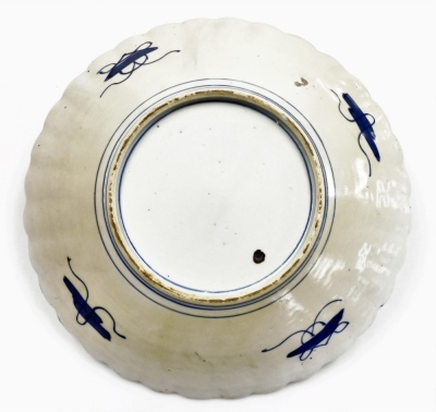 A Japanese Meiji period Imari charger, of fluted form, the centre decorated with vase and flowers surrounded by reserves of flowers, 30cm diameter. - 3