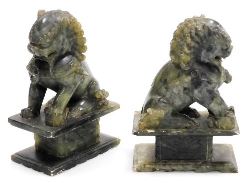 A pair of Chinese soapstone carved figures of dogs of fo, 18cm high.