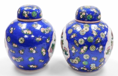 A pair of 20thC ginger jars and covers, decorated with birds on flowering branches against a blue ground, six character Qianlong mark in red to underside 27cm high. - 2