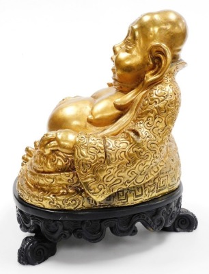 A gold coloured painted plaster figure of Putai, on stand, 34cm high. - 2