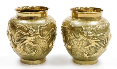 A pair of 20thC polished brass Chinese vases, with raised dragon decoration, 14cm high.