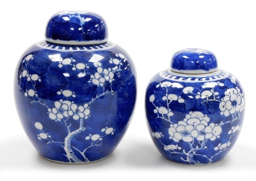 Two Chinese porcelain blue and white ginger jars in prunus pattern, one with four character Kangxi mark to base, 20cm high and 15cm high.