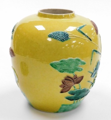 An early 20thC Chinese porcelain ginger jar, decorated in relief with stork and water lillies, on a yellow ground, with four character mark Wang Binrong to underside, the vase 24cm high. (the lid AF) - 4