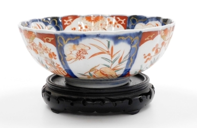 A 19thC Japanese Imari bowl, of fluted form, 25cm diameter, on hardwood stand. - 3