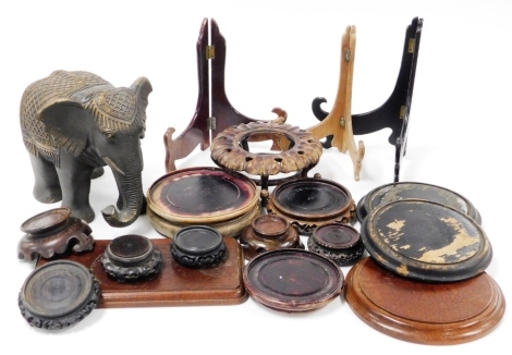 Various 19thC and later urn or vase stands in hardwood, plate easels and a modern elephant. (a quantity)