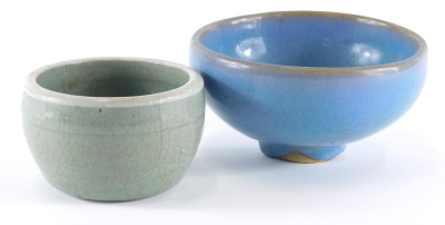 Two celadon glaze bowls, one in green, and one in blue with orange peel underside, 9cm and 13cm diameter.