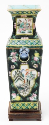 A 19thC Chinese famille noire square section tapering vase, with cartouches of figures in landscapes, banded in green and yellow diaper work, red six character Tongzhi mark to base, 23cm high plus hardwood stand. (AF) - 2